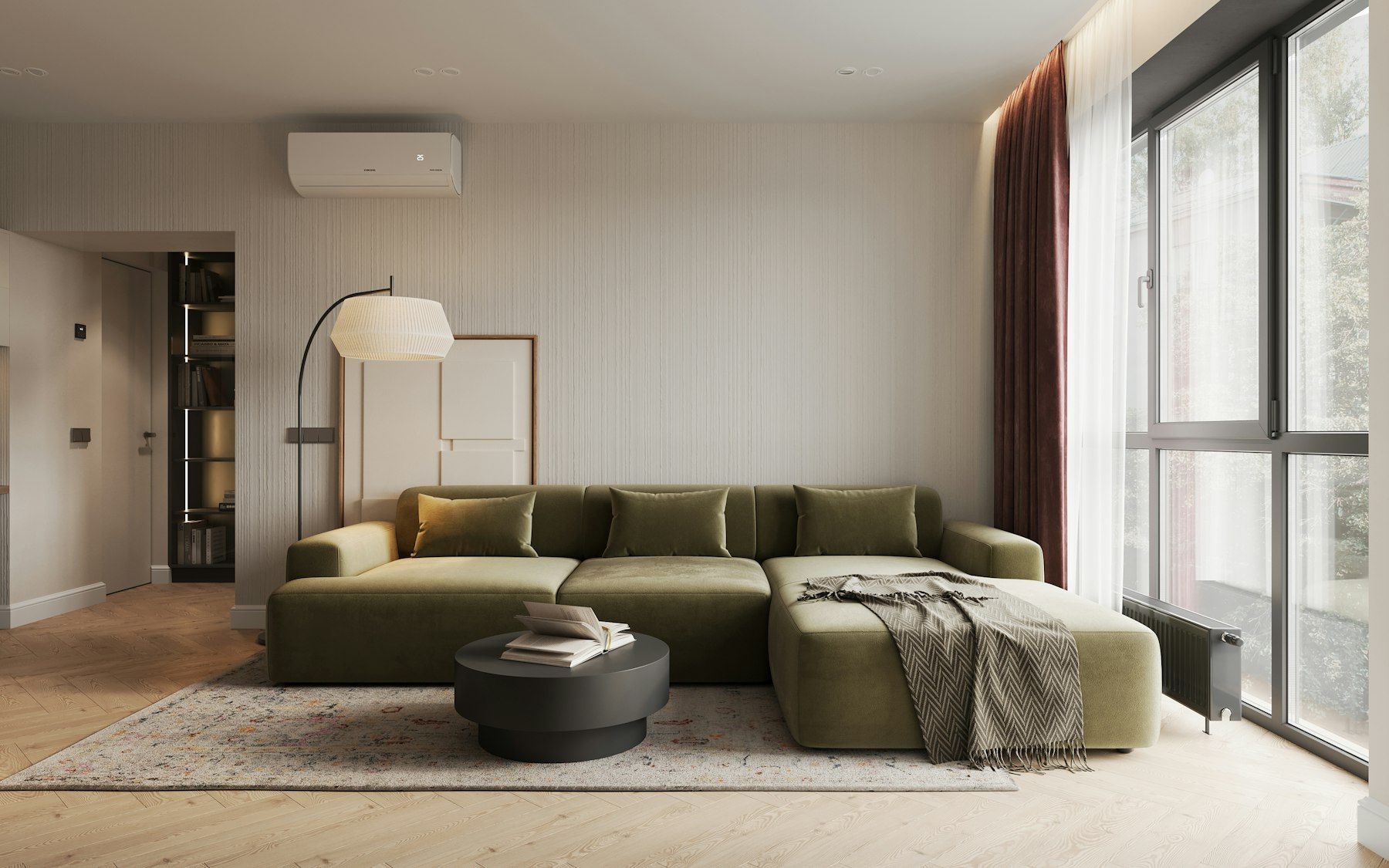 Salón con sofá verde, ventanal y un split de aire acondicionado en la pared